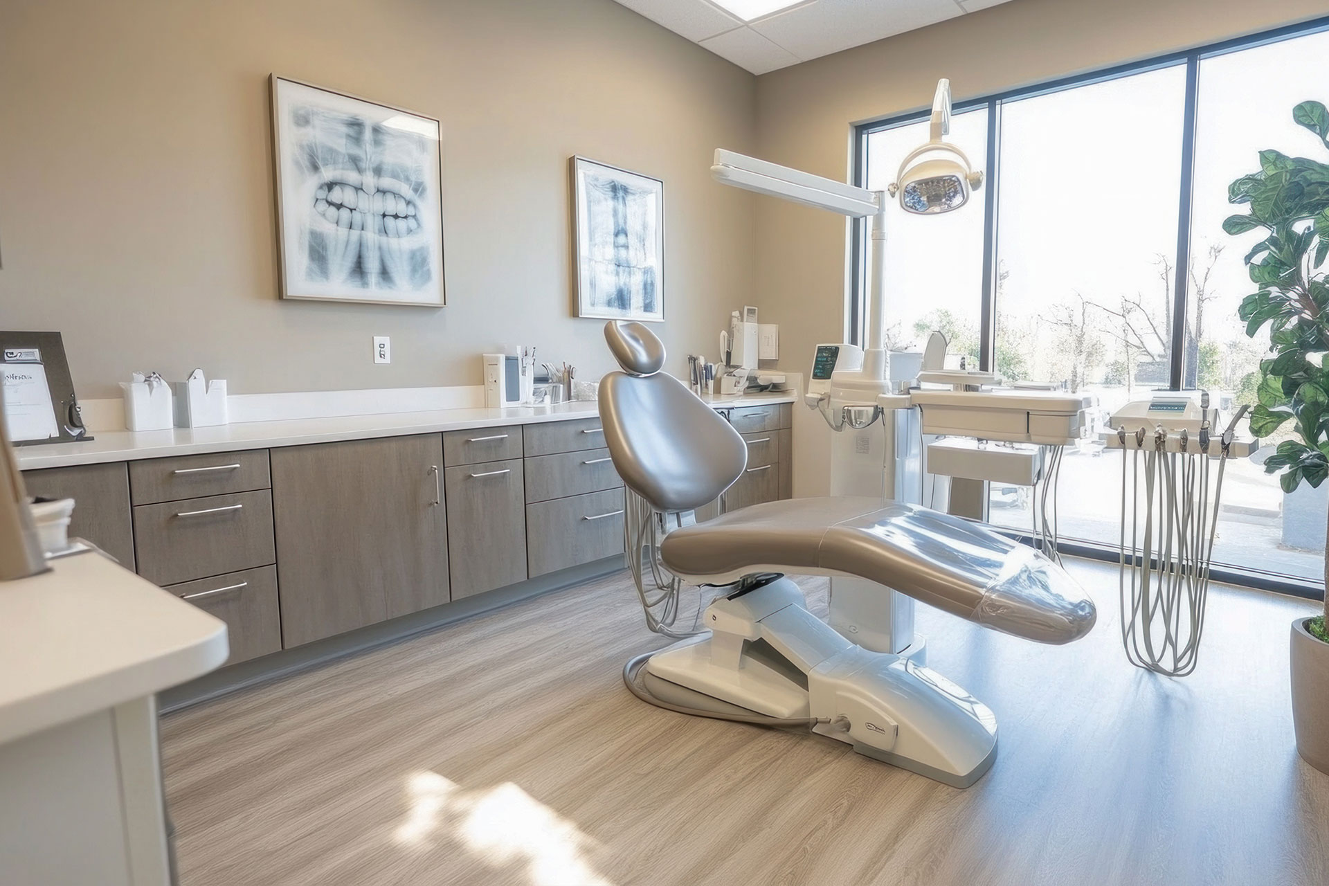 This is an interior view of a dental office with a modern dental chair, equipment, and a clean, well-lit environment.